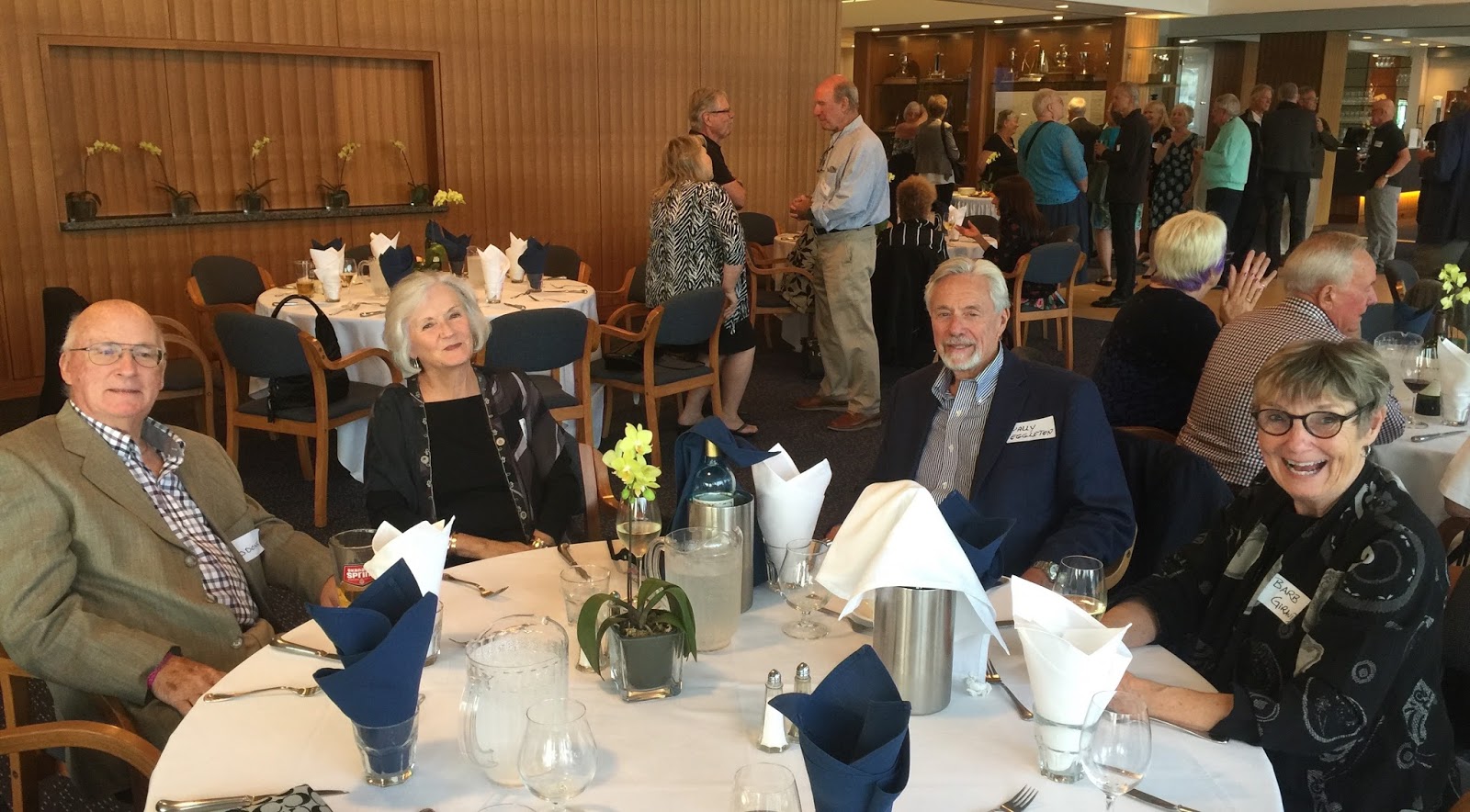 Classmates catching up at the Class of 1965 a shared 70th birthday